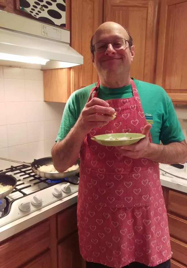 Terry testing latkes to make sure they're "OK"